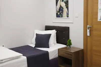 a bedroom with a bed and a table with a pillow at İstanbul Terrace Hotel in Istanbul
