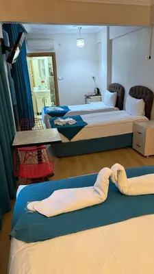 a room with two beds and a table in it at Galaxy Hotel Sultanahmet in Istanbul