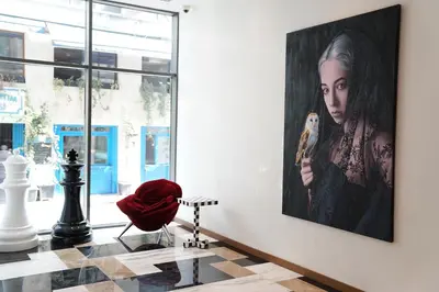 a room with a painting of a woman holding a brush at Galata's Hotel in Istanbul
