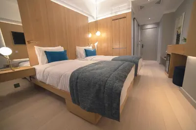 a large bedroom with a large bed with blue pillows at Galata's Hotel in Istanbul