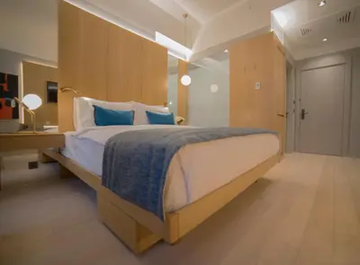 a bedroom with a large bed with blue pillows at Galata's Hotel in Istanbul