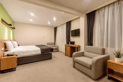 a hotel room with a bed and a chair at Bram Hotel Istanbul in Istanbul