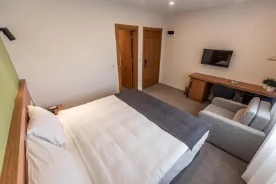 a bedroom with a bed and a couch and a television at Bram Hotel Istanbul in Istanbul