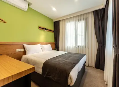 a hotel room with a bed and a window at Bram Hotel Istanbul in Istanbul
