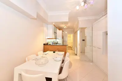 a white dining room with a white table and chairs at İskete Suit in Istanbul