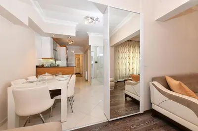 a kitchen and a dining room with a table and chairs at İskete Suit in Istanbul