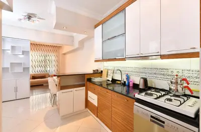 a kitchen with white cabinets and a stove top oven at İskete Suit in Istanbul