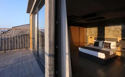 a bedroom with a bed on a balcony at Red Stone Hotel in Istanbul