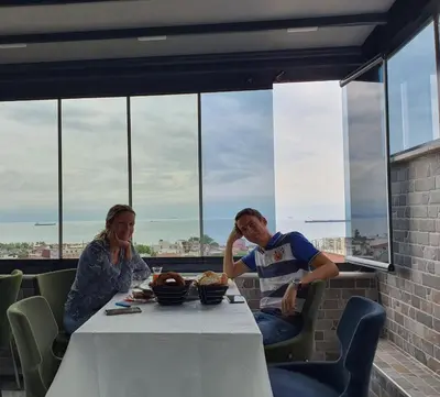 a man and woman sitting at a table in a restaurant at City Hall Hotel Sultanahmet in Istanbul