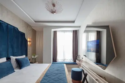 a hotel room with a large bed and a window at Danis Hotel & Spa Istanbul - Old City in Istanbul
