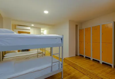 a dorm room with bunk beds and lockers at Sanat Hostel Taksim in Istanbul