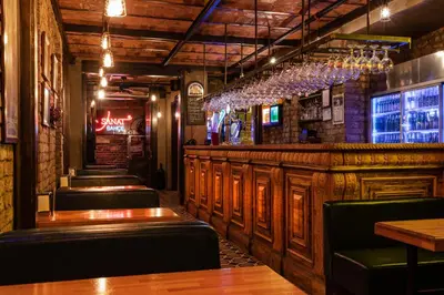 a bar with a row of seats in a restaurant at Sanat Hostel Taksim in Istanbul
