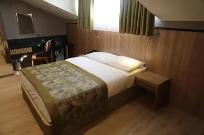 a bedroom with a bed and a desk and a chair at RADAR HOTEL in Istanbul