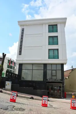 a large white building with signs in front of it at RADAR HOTEL in Istanbul