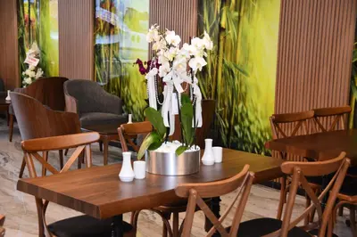 a table with a vase of white flowers on it at RADAR HOTEL in Istanbul