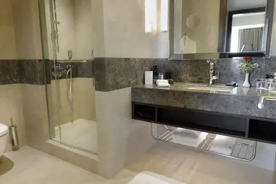 a bathroom with a sink and a shower at Wyndham Grand Istanbul Europe in Istanbul