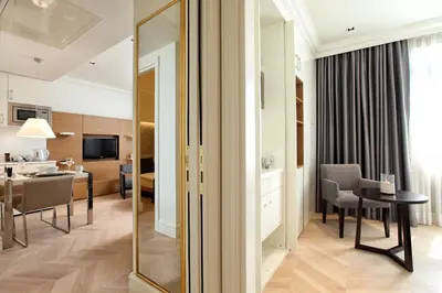 a living room with a mirror and a dining room at Stay Lab Taksim 15 Suites in Istanbul