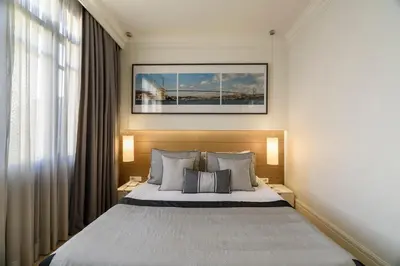 a bedroom with a large bed with two lamps and a window at Stay Lab Taksim 15 Suites in Istanbul