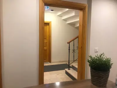 a hallway with a mirror and a stairway at Green Mansion in Istanbul