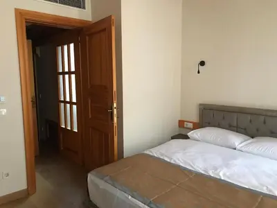 a bedroom with a bed and an open door at Green Mansion in Istanbul