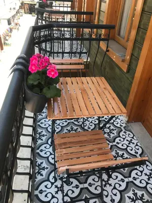 a row of benches on a balcony with pink flowers at Green Mansion in Istanbul
