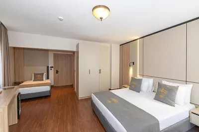 a hotel room with two beds and a television at Yez Boutique Hotel in Istanbul