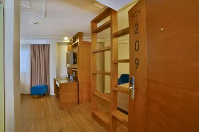 a hotel room with a book shelf and a desk at SORRISO HOTEL DUE in Istanbul