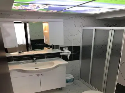 a bathroom with a sink and a mirror at Elit Palace Hotel in Istanbul