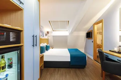 a small room with a bed and a kitchen at Urban Hotel Bomonti in Istanbul