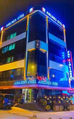 a building with neon signs on the side of it at Frt Airlines Hotel - Istanbul Airport in Arnavutköy