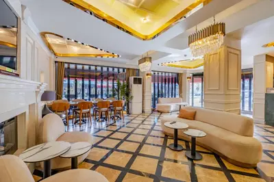 a lobby with a couch and tables and chairs at Frt Airlines Hotel - Istanbul Airport in Arnavutköy