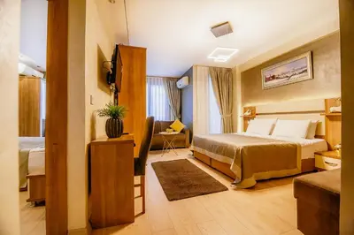 a hotel room with a bed and a television at Kavalalı Suites in Istanbul