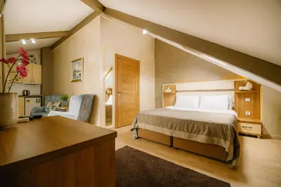 a bedroom with a bed and a desk in a room at Kavalalı Suites in Istanbul