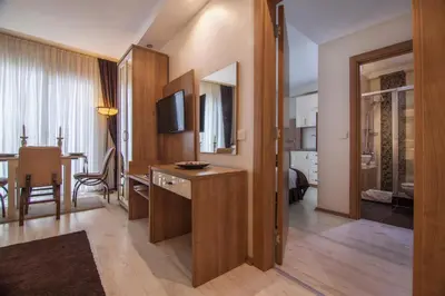 a living room with a desk and a television in a room at Kavalalı Suites in Istanbul