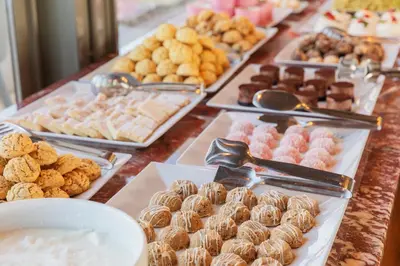 a buffet of different types of pastries and donuts on a table at Azade Premier Hotel in Istanbul