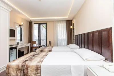 a hotel room with two beds and a kitchen at Morava Hotel in Istanbul
