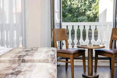 a bedroom with a bed and two chairs and a window at Morava Hotel in Istanbul
