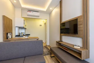 a living room with a couch and a flat screen tv at MENAR HOTEL&SUITES -Old City Sultanahmet in Istanbul