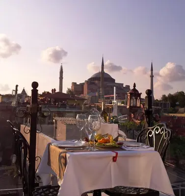 a table with wine glasses and a view of the city at Mytra Hotel in Istanbul