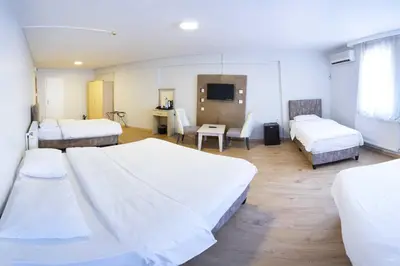 a hospital room with two beds and a desk at Hotel Libiza in Gebze
