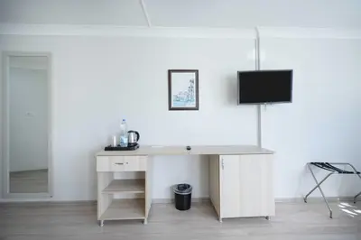 a white desk with a television on a wall at Hotel Libiza in Gebze