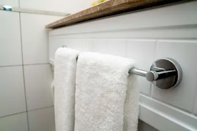 a bathroom with white towels hanging on a towel rack at Mugwort Hotel & Spa in Istanbul