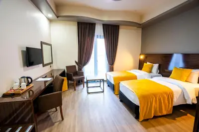 a hotel room with two beds and a television at Mugwort Hotel & Spa in Istanbul