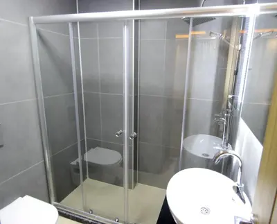 a bathroom with a shower with a toilet and a sink at Hira Hotel in Istanbul