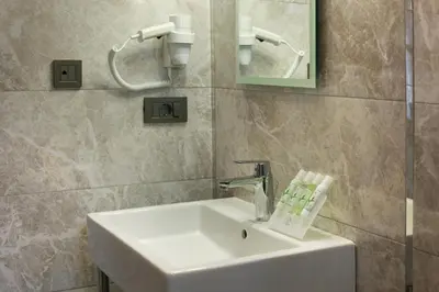 a bathroom with a white sink and a mirror at The Fox Hotel in Istanbul