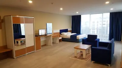 a hotel room with a bed and a couch and a chair at SKYBLUE İSTANBUL HOTEL in Istanbul