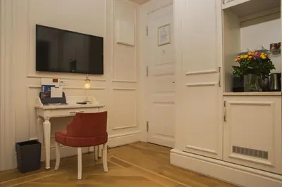 a room with a desk with a television and a chair at Corinne Art & Boutique Hotel in Istanbul