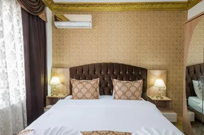 a bedroom with a large bed and two lamps at Punto Suite in Istanbul