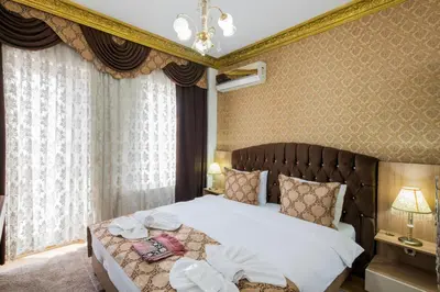 a bedroom with a large bed with white sheets at Punto Suite in Istanbul