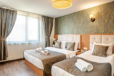 a hotel room with two beds with towels on them at The Camelot Hotel in Istanbul